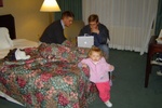 Dave and Jason hunch intensely over Jason's new Apple PowerMac IV in Nancy's hotel room in Provo. Molly stands nonchalontly by waiting for the computer nerds to finish their work.